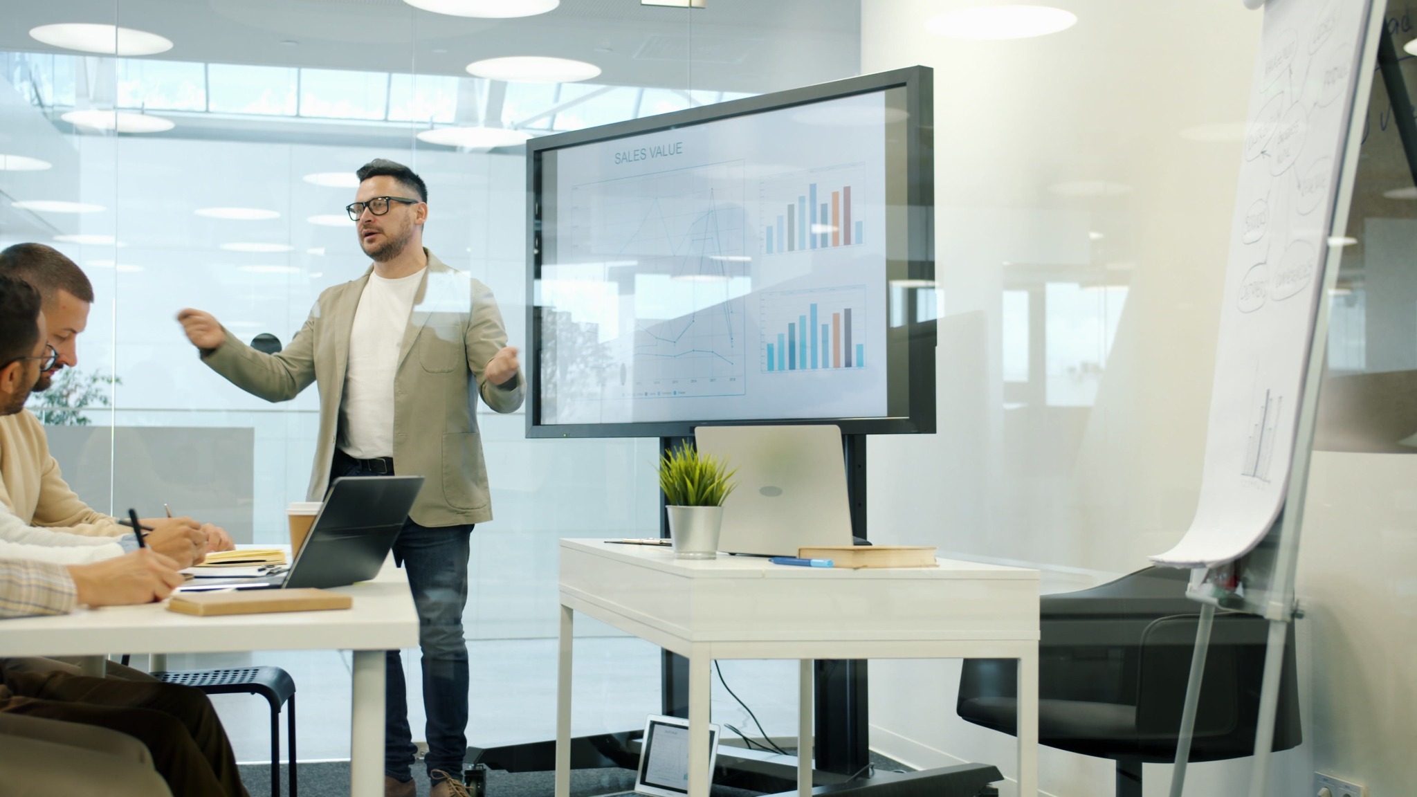 Sales professional presenting a sales deck to a team